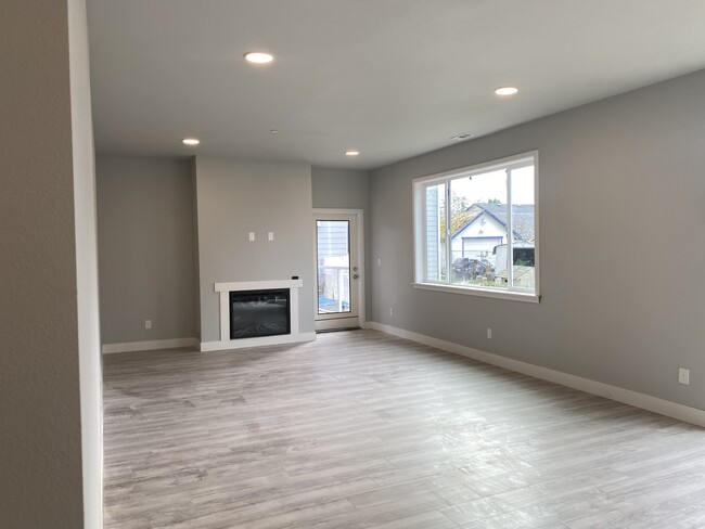 Open concept living room with an electric fireplace - 812 E 68th St