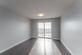 This well-appointed 2-bedroom, 2-bathroom unit at 15 Lena Cres in Cambridge, Ontario offers a comfortable and functional single-floor layout. The welcoming entrance features mirrored sliding closet doors, opening into a bright hallway that connects all areas of the unit. Rich dark hardwood flooring flows through the main living spaces, while light tile anchors the kitchen and bathrooms.

The open-concept living and dining area is generously sized, filled with natural light from large sliding glass doors that lead to a private balcony with sweeping outdoor views of the surrounding neighbourhood. The kitchen is well-equipped with dark espresso cabinetry, granite-style countertops, stainless steel appliances including a refrigerator and dishwasher, and a tile floor for easy maintenance.

The primary bedroom is a comfortable retreat with mirrored sliding closet doors and light laminate flooring. The second bedroom is equally bright with a clean, neutral palette. Both bathrooms are functional and tidy — one features a walk-in shower with a vanity with stone countertop, while the other offers a full soaker tub. A dedicated in-unit laundry room with tile flooring adds everyday convenience. The unit also includes an additional closet for storage.