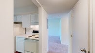 Located at 711 Kimberly in Lake Orion, Michigan, this one-bedroom unit offers a well-organized, single-floor layout designed for comfortable everyday living. The living area is carpeted and generously sized, anchored by a large sliding glass door fitted with vertical blinds that opens directly onto a private balcony. The outdoor views of surrounding greenery bring a sense of calm and connection to nature, while allowing natural light to fill the interior throughout the day.

The bedroom is a spacious, carpet-floored retreat featuring a large window with vertical blinds that continues the theme of bright, natural illumination. A louvered closet door provides dedicated storage within the room, and an adjoining bathroom with vanity cabinetry is conveniently accessible directly from the bedroom. A second closet elsewhere in the unit offers additional storage capacity.

The kitchen area, visible in the floor plan, features hard-surface flooring and is positioned centrally to serve both the living and dining areas efficiently. The neutral wall tones and clean finishes throughout the unit create a bright, move-in-ready atmosphere. Overall, the space presents a practical and inviting layout well-suited for individuals or couples seeking a comfortable home in the Lake Orion community.