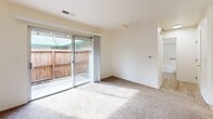 Located at 280 Oak Ave in Galt, CA, this single-floor, 2-bedroom, 1-bathroom home offers a well-organized layout designed for comfortable everyday living. The living room is a bright, carpeted space anchored by a ceiling fan and flows seamlessly into an adjacent dining area and kitchen. The kitchen is equipped with white cabinetry and a white range, with light hardwood-style flooring that contrasts with the warm carpet throughout the rest of the home. A sliding glass door in the primary bedroom opens to a private outdoor patio area enclosed by a wood fence, allowing natural light to fill the room. The primary bedroom is a generously sized retreat featuring two sets of sliding closet doors, providing substantial storage space. The second bedroom is a cozy, carpeted room with a window offering natural light and outdoor views. A hallway connects the bedrooms to the full bathroom, which features a tub-shower combination with grab bars, a vanity with a stone-style countertop, and light wood-style flooring. With three closets distributed throughout the unit, this home offers practical storage solutions at every turn.