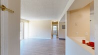 Located at 742 Western Dr in Colorado Springs, CO, this single-floor, 2-bedroom, 3-bathroom home offers a well-organized layout designed for comfortable everyday living. The open living and dining area is a standout feature, showcasing light luxury vinyl plank flooring, a textured ceiling, and a tile-surround fireplace with a wood mantel that serves as an inviting focal point. A wall-mounted mini-split unit provides efficient climate control, while a sliding glass door fills the space with natural light and provides direct outdoor access. The kitchen is equipped with stainless steel appliances, including a refrigerator and range, complemented by white shaker cabinetry, a subway tile backsplash, and light flooring that ties the space together. Both bedrooms feature plush carpeting and receive ample natural light through multiple windows. The primary bedroom offers a comfortable, well-proportioned retreat. Three bathrooms serve the home, one of which includes a vanity with white cabinetry and a shower/tub combination. Additional conveniences include a dedicated laundry area, a hallway connecting the main spaces, and three closets providing generous storage throughout. The overall ambiance is clean, neutral, and move-in ready.