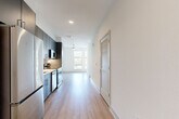 Located at 7400 S Addison Ct in Aurora, CO, this modern one-bedroom, one-bathroom residence offers a well-planned single-floor layout with clean contemporary finishes throughout. Light wood-tone flooring flows seamlessly across every room, creating a cohesive and bright atmosphere. The open-concept living, dining, and kitchen area forms the heart of the unit, with the kitchen serving as a standout feature. It is equipped with stainless steel appliances — including a refrigerator, range, microwave, and dishwasher — complemented by sleek gray cabinetry, white quartz countertops, a tile backsplash with under-cabinet lighting, and a stainless steel sink. A ceiling fan in the living area and a large window bring in natural light and outdoor views of surrounding greenery. The bedroom is a comfortable, well-lit space with multiple windows framing tranquil landscape views and generous wall space. The full bathroom features a blue-gray vanity with white countertop, a large mirror, and a tiled shower and tub combination. Additional highlights include a walk-in closet with hanging rods, a dedicated laundry area, a utility room, and a built-in desk shelf. Recessed lighting and a louvered interior door add thoughtful design details throughout.