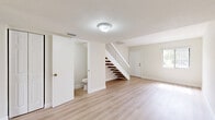 Located at 8340 NW 7th St in Miami, FL, this two-story, 2-bedroom, 2-bathroom home offers a clean, modern aesthetic throughout. Light wood-style flooring flows seamlessly across both levels, complementing the crisp white walls and creating a bright, airy ambiance. The main floor features an open-concept living and dining area filled with natural light, a well-appointed kitchen, and a conveniently located bathroom. The kitchen stands out with warm wood-tone cabinetry, granite-style countertops, and a full suite of stainless steel appliances including a refrigerator, range, dishwasher, and built-in microwave hood. A staircase with wood-tone treads and white railings leads to the upper floor, where both bedrooms are situated. Each bedroom is generously sized, featuring large windows with vertical blinds that allow ample natural light and views of the outdoors. The primary bedroom includes dual closets, providing notable storage capacity. The upper-level bathroom is well-finished, featuring full tub-shower tile surround in a neutral stone pattern, a wood-tone vanity with a light countertop, and light wood-style flooring. Additional features include four closets throughout and an in-unit laundry area, rounding out the practical and functional layout of this Miami home.