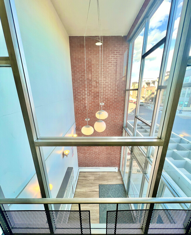 Experience urban elegance with this loft's expansive windows and contemporary design elements. - Harmony Apartments