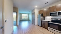 Located at 7600 Cabot Dr in Nashville, TN, this one-bedroom, one-bathroom residence offers a well-designed, single-level floor plan with a thoughtful mix of style and functionality. The open-concept living and dining area features light hardwood-style flooring, neutral walls, and a large window that invites generous natural light and views of the surrounding greenery. A sliding glass door leads to a private balcony overlooking lush tree canopies, extending the living space outdoors.

The kitchen is a standout, equipped with a full suite of stainless steel appliances — including a refrigerator, range, microwave, and dishwasher — complemented by rich dark cabinetry, granite countertops, and a classic white subway tile backsplash. Recessed lighting enhances the clean, modern aesthetic.

The bedroom is carpeted for comfort and features a ceiling fan, ample natural light, and a sliding glass door that opens to the balcony. A dedicated walk-in closet with wire shelving provides practical storage. The bathroom continues the upscale finishes with a granite vanity, dark cabinetry, a glass-enclosed shower, and hardwood-style flooring. This residence combines modern finishes with a functional layout in a desirable Nashville location.