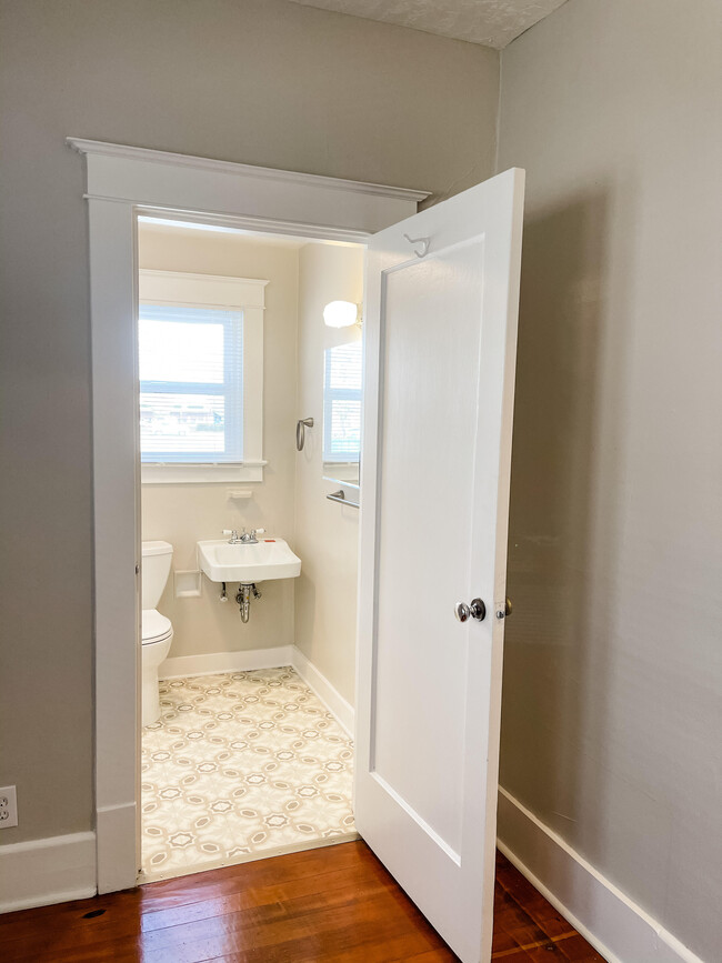 Bathroom with new floors, sink and vanity. - 6 Nineteen Apartments