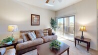 Located at 2299 Oakmont Dr in Sierra Vista, Arizona, this single-floor, 2-bedroom, 2-bathroom home offers a practical and comfortable layout with well-defined living spaces throughout. The open-concept kitchen and living area serves as the heart of the home, where warm wood cabinetry with ample storage rises to the ceiling, complemented by granite-style countertops, a breakfast bar, and black appliances including a refrigerator, range, and microwave. The adjoining living room is bright and welcoming, featuring plush carpeting, a ceiling fan, and a sliding glass door that opens to an outdoor area, flooding the space with natural light and outdoor views. The primary bedroom is generously sized, offering carpet flooring, a ceiling fan, a large window with blinds, and ample room for a dresser and workspace. The second bedroom is cozy and well-proportioned, also finished with carpet and natural light. Both bathrooms feature warm wood vanities with white countertops and tile flooring—the primary bath offering a dual-sink vanity, while the second bath includes a single vanity with a large mirror. A dedicated laundry room houses a full-size washer and dryer alongside a water heater, adding everyday convenience. Tile flooring at the entryway transitions seamlessly to carpet throughout the main living areas, creating a cohesive and inviting atmosphere.