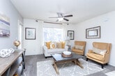 Located at 46 E Point Dr in Draper, Utah, this single-floor, one-bedroom, one-bathroom residence offers a well-organized and efficiently designed layout. The combined kitchen and living area serves as the heart of the home, where a ceiling fan-equipped living room features plush carpeting, large windows with sheer drapes, and a private patio door that floods the space with natural light. A dedicated console area and tiled entryway add functional character to the room.

The kitchen is appointed with white cabinetry, laminate countertops, a full suite of appliances including a dishwasher and microwave, and a peninsula breakfast bar with seating — connected to the living area through a charming arched passageway. Tile flooring completes the kitchen's clean, practical aesthetic.

The bedroom is a comfortable, well-lit retreat featuring carpeted floors, a large window with neighborhood views, and warm accent wall tones. An adjacent closet provides convenient storage. The full bathroom includes a single-sink vanity with a large mirror, tile flooring, and a full tub/shower combination. A utility room and hallway round out the thoughtfully arranged floor plan, making this a complete and functional living space.
