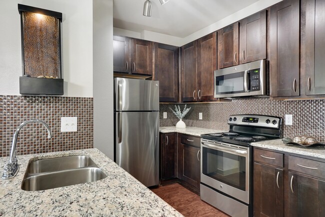 Kitchen with Stainless Steel Appliances and dark brown cabinets - Villas di Lucca