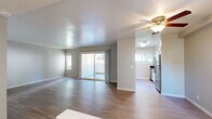 Located on Kings Way in Sacramento, CA, this single-story residence offers a thoughtfully designed floor plan across two bedrooms and two full bathrooms. The living room is bright and open, featuring light wood-style flooring, neutral gray walls, and a large sliding glass door that leads to a private patio while framing views of surrounding greenery. A side window further enhances the natural light throughout the space.

The galley-style kitchen is efficiently designed with crisp white cabinetry, dark countertops, stainless steel appliances including a refrigerator and range, and a window at the far end bringing in additional natural light. A ceiling fan connects the kitchen visually to the living area, creating a cohesive, functional layout.

The generously sized primary bedroom offers plush carpeting, neutral tones, and a connected bathroom featuring a vanity with white cabinetry and a tub-shower combination. The second bedroom is carpeted as well, filled with natural light from a corner window, and includes mirrored sliding closet doors. Both bathrooms are finished with wood-style flooring, tub-shower combos, and clean, understated fixtures.

Throughout the residence, consistent use of light, neutral tones and a mix of wood-style and carpeted flooring creates a cohesive, move-in-ready aesthetic.