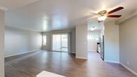Located on Kings Way in Sacramento, CA, this single-story residence offers a thoughtfully designed floor plan across two bedrooms and two full bathrooms. The living room is bright and open, featuring light wood-style flooring, neutral gray walls, and a large sliding glass door that leads to a private patio while framing views of surrounding greenery. A side window further enhances the natural light throughout the space.

The galley-style kitchen is efficiently designed with crisp white cabinetry, dark countertops, stainless steel appliances including a refrigerator and range, and a window at the far end bringing in additional natural light. A ceiling fan connects the kitchen visually to the living area, creating a cohesive, functional layout.

The generously sized primary bedroom offers plush carpeting, neutral tones, and a connected bathroom featuring a vanity with white cabinetry and a tub-shower combination. The second bedroom is carpeted as well, filled with natural light from a corner window, and includes mirrored sliding closet doors. Both bathrooms are finished with wood-style flooring, tub-shower combos, and clean, understated fixtures.

Throughout the residence, consistent use of light, neutral tones and a mix of wood-style and carpeted flooring creates a cohesive, move-in-ready aesthetic.