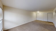 This single-floor unit at 4301 Riverside Dr in Dayton, Ohio offers a practical and efficient layout across two bedrooms, one bathroom, a kitchen, a utility room, and a connecting hallway. The spacious primary bedroom features neutral-toned carpet, bright white walls, and a wide sliding double-door closet, providing ample storage. The second bedroom is similarly carpeted with white walls and its own sliding closet doors, offering a clean, versatile space.

The kitchen is equipped with warm wood-toned cabinetry, granite-style countertops, a stainless steel sink, and black appliances including an electric range and refrigerator. Wood-look flooring runs through the kitchen and hallway areas, creating a clear visual distinction between the living and sleeping zones. A louvered closet door in the hallway provides additional storage access.

The bathroom features a full tub-shower combination with white tile surround, wood-look flooring, a white vanity with sink, and chrome fixtures, maintaining a clean and functional aesthetic throughout. The unit's neutral color palette and straightforward layout offer a practical living environment with natural light accessible through sliding windows in the living area.