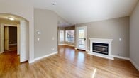 Located at 3001 Kodiak St in Antioch, CA, this well-appointed 2-bedroom, 2-bathroom residence offers a thoughtfully designed single-floor layout. The living room is an immediate standout, featuring soaring vaulted ceilings, a classic white-mantled fireplace, and gleaming hardwood-style flooring that reflects abundant natural light streaming through large windows, including a distinctive arched window. A sliding door provides direct access to a private balcony, seamlessly blending indoor and outdoor living.

The kitchen and dining area are combined into one functional space, outfitted with white shaker cabinetry, granite-style countertops, and a full suite of stainless steel appliances including a range, microwave, and dishwasher. The warm wood flooring continues throughout this area, maintaining a cohesive aesthetic.

Both bedrooms are carpeted for comfort and benefit from natural light via well-positioned windows. The spacious primary bedroom features vaulted ceilings that add an airy feel. Each bedroom is served by ample closet storage across three closets total.

The two bathrooms are finished with tile flooring, white vanities, granite-topped counters, and glass-door shower enclosures. Additional conveniences include in-unit laundry and a connecting hallway that ties the layout together efficiently.
