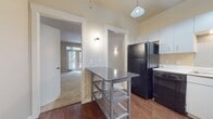 This well-designed apartment in Legacy Village Apartment Homes offers 940 square feet of comfortable living space. The layout includes three bedrooms, with the primary bedroom boasting a generous 270 square feet. Two full bathrooms provide convenience for residents and guests alike.

The modern kitchen is equipped with white cabinetry, black appliances, and a tiled backsplash, creating a sleek and functional cooking space. Wood-look flooring in the kitchen and bathrooms adds warmth and durability to these high-traffic areas.

Plush carpeting in the bedrooms and living areas ensures comfort underfoot. Large windows in the bedrooms allow for ample natural light, while vertical blinds offer privacy control. The bathrooms feature a combination tub/shower with tiled surrounds and a granite-topped vanity.

Storage is abundant with two closets, including walk-in options with built-in shelving and hanging rods. The neutral color palette throughout the apartment provides a versatile backdrop for various decorating styles.

This single-story apartment combines practicality with modern aesthetics, offering a comfortable living environment in the desirable Legacy Village community.
