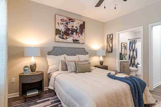Cozy bedroom with ensuite bathroom and walk-in closet. - Waterstone at Big Creek Apartments