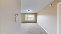 Located at 3705 S Broadway St in Alexandria, Minnesota, this single-floor, 3-bedroom, 2-bathroom unit offers a well-organized layout across a comfortable footprint. The kitchen is a functional centerpiece, featuring warm honey-toned oak cabinetry, a peninsula with double sink, recessed lighting, and white appliances including a range, microwave, and refrigerator. Stone-look tile flooring extends through the kitchen and both bathrooms, adding durability and a cohesive aesthetic. Both bathrooms are outfitted with matching warm wood vanities, light countertops, large mirrors, and oil-rubbed bronze fixtures, lending a consistent, classic style throughout. The three bedrooms are carpeted in neutral tones with clean white walls and trim, providing a bright and versatile canvas. The generously sized primary bedroom includes a wide double-door closet and is the largest of the three rooms. The two additional bedrooms each feature windows that bring in natural light and views of the surrounding exterior. White six-panel doors are used consistently throughout the unit, reinforcing a tidy, uniform interior design. The overall ambiance of the space is clean, neutral, and move-in ready, well suited for comfortable everyday living in a quiet Alexandria community.
