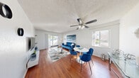 Located in Pompano Beach, Florida, this 2-bedroom, 1-bathroom unit offers a well-designed single-floor layout with a clean, modern aesthetic throughout. A welcoming hallway with wood-style flooring leads into the open living area, where a ceiling fan, textured ceiling, and sliding glass door to the private balcony create a bright and airy atmosphere. Natural light fills the combined living and dining space, which comfortably accommodates both a seating area and a dining set. The kitchen is well-appointed with warm wood cabinetry, dark granite-style countertops, a tile backsplash, and stainless steel appliances including a refrigerator and electric range. The primary bedroom is a comfortable retreat featuring wood-style flooring, a window with natural light, and access to a dedicated closet. The second bedroom mirrors the clean, bright design of the primary. The full bathroom includes a tub-shower combination with white tile surround. Five closets throughout the unit provide generous storage. The private balcony adds outdoor living space, rounding out this well-organized and efficiently utilized Pompano Beach residence.
