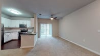 This single-floor 1-bedroom, 1-bathroom unit offers a functional and comfortable layout with quality finishes throughout. The open living area is anchored by plush carpeting, neutral-toned walls, and a ceiling fan, creating a bright and inviting atmosphere. Sliding glass doors with vertical blinds lead to an outdoor patio, allowing natural light to flow freely into the space.

The kitchen is well-equipped and designed for efficiency, featuring white shaker-style cabinetry, dark granite countertops, a subway tile backsplash, and a full suite of stainless steel appliances including a range, over-the-range microwave, dishwasher, and refrigerator. Rich wood-look flooring adds warmth to the kitchen area, while a peninsula with a sink provides convenient pass-through access to the living space.

The bedroom is generously sized with soft carpeting, a ceiling fan, a window with natural light, and access to a large walk-in closet outfitted with dual hanging rods and shelving on multiple walls — offering ample storage. The bathroom features wood-look tile flooring, a white vanity with dark countertop, and a well-lit mirror. A dedicated hallway connects the bedroom and bathroom, enhancing privacy and flow throughout the unit.