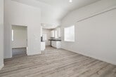 This single-story home in Idaho Falls, Idaho offers a thoughtfully designed floor plan with two bedrooms, one bathroom, and a generous overall footprint. The open-concept living and kitchen area forms the heart of the home, where vaulted ceilings amplify the sense of space and light-toned luxury vinyl plank flooring flows throughout. Natural light pours in through multiple windows, creating a bright and welcoming atmosphere.

The kitchen is well-appointed with white shaker-style cabinetry, dark countertops, stainless steel appliances including a range, microwave, refrigerator, and dishwasher, along with a pantry for additional storage. A door from the kitchen provides direct access to the exterior.

The spacious primary bedroom features vaulted ceilings and a double-door closet, while the second bedroom offers a comfortable layout with a large window overlooking the yard. Three closets total provide ample storage throughout the home. The bathroom includes a full tub/shower combo with clean white surrounds.

Externally, the home showcases a modern gray board-and-batten exterior with well-maintained green lawns on multiple sides. The surrounding neighborhood features a quiet, newly developed streetscape with open views and a concrete driveway, completing this move-in-ready Idaho Falls residence.