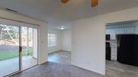 Located at 208 Partners Way in Fayetteville, North Carolina, this single-floor home offers a well-organized layout with clean, neutral finishes that create a bright and welcoming atmosphere throughout. The living area features plush carpeting and a ceiling fan, with a sliding glass door that opens to an outdoor view, allowing natural light to fill the space. An adjoining room with wood-look flooring and a window with blinds provides additional flexible living space.

The kitchen is efficiently designed with white cabinetry, light granite-style countertops, a stainless steel double-basin sink, a pendant light, and black appliances, including a range and microwave. A window above the sink brings in natural light, enhancing the clean, functional aesthetic.

The bedrooms are comfortably sized, each featuring soft carpeting, ceiling fans with light fixtures, and windows dressed with blinds that provide both privacy and natural light. The bathroom includes a granite-topped vanity with an undermount sink and wood-look flooring, along with a full bathtub and shower combination. Additional storage is accessible via closet doors off the bathroom hallway. The textured ceilings and consistent white walls throughout contribute to the home's cohesive, move-in-ready feel.