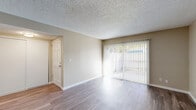 Located at 2405 Walnut Ave in Carmichael, CA, this 2-bedroom, 1-bathroom single-story residence offers a well-organized layout across a comfortable footprint. The living room serves as the heart of the home, featuring wood-style laminate flooring, neutral beige walls, a textured ceiling, and a full-width sliding glass door dressed with vertical blinds that fills the space with natural light and provides outdoor access. Adjacent to the living area, the dining room connects seamlessly to the galley-style kitchen, which is equipped with white cabinetry, granite-style countertops, a breakfast bar with an undermount sink, white appliances including a refrigerator and electric range, and a dishwasher — all complemented by the same wood-style flooring. Both bedrooms are carpeted and well-proportioned, with the primary bedroom offering direct access to the shared bathroom. Each bedroom benefits from natural light via windows with blinds. The bathroom features wood-style flooring, a granite-style vanity countertop, and a full shower-tub combo. Three closets throughout the unit provide ample storage. A dedicated hallway and entrance complete this efficiently designed, move-in ready home.