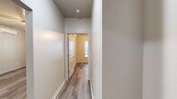 This contemporary 840 square foot residence offers a well-designed living space with 2 bedrooms and 3 bathrooms. The home showcases an open floor plan, emphasizing a seamless flow between rooms. The kitchen is a standout feature, boasting light gray cabinetry, stainless steel appliances, and ample counter space, perfect for culinary enthusiasts.

Throughout the home, wood-look flooring adds warmth and durability. Large windows in the bedrooms and living areas allow for plenty of natural light, creating a bright and airy atmosphere. The bathrooms are outfitted with modern fixtures and vanities, maintaining the home's overall sleek aesthetic.

Climate control is ensured through ceiling fans and wall-mounted air conditioning units. The property also includes practical amenities such as a dedicated laundry area with a water heater. With its efficient use of space and modern design elements, this home offers comfortable living in a compact footprint.