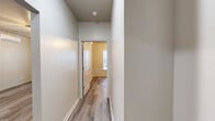 Located at 5339 US-319 S in Thomasville, Georgia, this single-story, 2-bedroom, 2-bathroom home offers a clean, modern aesthetic throughout. The open-concept living, dining, and kitchen area provides a bright and functional gathering space, anchored by a well-equipped kitchen featuring gray shaker-style cabinetry, white countertops, stainless steel appliances including a refrigerator and electric range, and a stainless steel sink. A wall-mounted mini-split system and ceiling fans ensure year-round comfort throughout the home. Light-toned luxury vinyl plank flooring runs seamlessly through every room, lending a cohesive and low-maintenance quality to the interior. Both bedrooms are generously proportioned, each fitted with ceiling fans and windows that invite natural light and outdoor views. The two bathrooms mirror the home's modern styling, featuring gray vanity cabinetry, white countertops, illuminated mirrors, and soaking tubs with tiled surrounds. Two hallways connect the living spaces to the private quarters, and two closets provide practical storage. A dedicated laundry and utility room with wire shelving and a water heater rounds out the functional layout. The overall ambiance is fresh, neutral, and move-in ready.