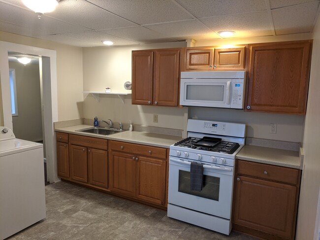 Good size kitchen with overhead lighting. Brand new Convection Range and Microwave. Upper and lower cabinets with lots of counter space. - 8 Grand Street