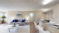 Located at 518 Lake Bridge Ln in Apopka, FL, this thoughtfully designed one-bedroom, one-bathroom residence makes excellent use of its single-floor layout. The open-concept living and dining area flows seamlessly into the kitchen, creating a bright and cohesive common space. Wood-style flooring runs throughout the main living areas, complementing the warm, neutral color palette found across the home.

The kitchen is outfitted with honey-toned cabinetry, dark countertops, black appliances including an electric range and refrigerator, and a raised breakfast bar that doubles as a casual dining surface. A separate dining nook provides additional space for meals and entertaining.

The living room is generously sized for the footprint, offering comfortable space with a textured ceiling and easy access to both the kitchen and private areas of the home. The bedroom features carpeted flooring, a window with natural light, and direct access to a closet, providing a calm and restful retreat.

The bathroom includes a full tub-shower combination, wood-toned vanity cabinetry with dark countertops, and hardwood-style flooring. A standout feature is the dedicated office, bathed in natural light from large windows overlooking lush greenery, and equipped with a ceiling fan and closet — ideal for remote work or a flex room.