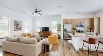 Located at 1450 Front Pl in North Port, Florida, this two-story, 3-bedroom, 3-bathroom home offers a thoughtfully designed layout spread across two floors. The main floor hosts the primary living areas, including a bright, open-concept living room and kitchen that flow seamlessly together. The living room features wood-look flooring, a ceiling fan, and multiple windows that flood the space with natural light. The kitchen is equipped with stainless steel appliances, light wood cabinetry, granite countertops, and a center island. A bathroom on the main floor mirrors the same refined aesthetic, with a granite-topped vanity and wood-toned cabinetry. The upper floor accommodates the bedrooms, including a generous primary suite with soaring ceilings, large windows with outdoor views, a ceiling fan, and a private en-suite bathroom featuring a walk-in shower and granite vanity. Additional bedrooms are well-proportioned and bright, with ample closet space. A versatile flex room offers space for a home office or study. With five closets, two staircases, and a private patio, this home balances functionality and modern comfort throughout.