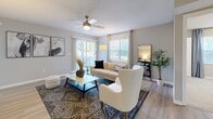 Located at 1000 Woodbrook Pl NE in Concord, NC, this single-floor, three-bedroom, two-bathroom residence offers a well-designed layout with modern finishes throughout. Light-toned luxury vinyl plank flooring flows through the main living areas, complementing the neutral color palette that creates a bright and cohesive atmosphere.

The living room is a comfortable, well-lit space featuring a ceiling fan, large windows with vertical blinds and curtain panels that invite natural light, and direct sightlines to the adjoining dining and kitchen areas. The dining area accommodates a round table and provides a defined space for meals, accented by framed wall art.

The kitchen is thoughtfully appointed with white shaker-style cabinetry, black hardware, granite-look countertops, a classic subway tile backsplash, and a full suite of stainless steel appliances including a refrigerator, dishwasher, and range.

The primary bedroom offers a generous footprint with carpet flooring and natural light from a large window. Two additional bedrooms provide flexibility for guests or a home office. The bathrooms are clean and functional, with one featuring a full tub-shower combination with chrome fixtures. A dedicated closet provides additional storage within the unit.