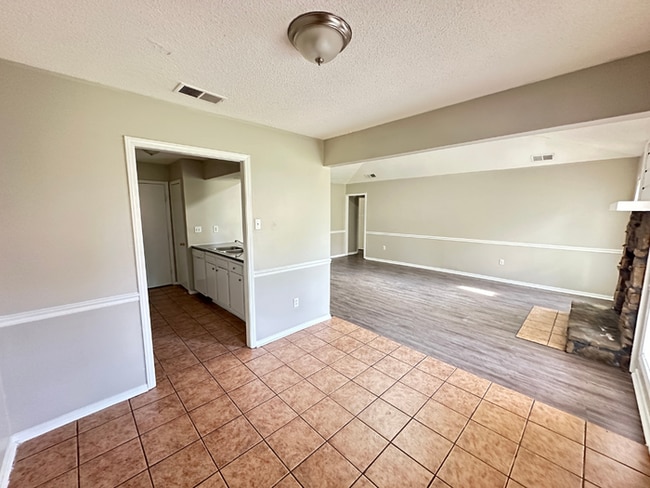 Building Photo - Charming 3BR/2BA Near Southwind | Soaring Vaulted Ceilings, Rustic Fireplace & Garage