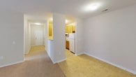 This single-floor, 2-bedroom, 2-bathroom residence offers a practical and comfortable layout designed for everyday living. The main living area features light-toned tile flooring that transitions into soft, neutral-colored carpet in the bedrooms and connecting hallways, creating a cohesive and inviting atmosphere throughout.

The kitchen is positioned just off the main living space, separated by a partial partition wall that lends a semi-open feel. It is equipped with warm honey-toned wood cabinetry, ample counter space with light laminate surfaces, a white refrigerator, and an electric range — providing all the essentials for a well-functioning kitchen. Tile flooring continues through this area, making for easy maintenance.

Both bedrooms are generously sized, each featuring plush carpeting, neutral wall tones, and windows fitted with horizontal blinds that allow for adjustable natural light. Closet space is provided in the bedrooms, offering practical storage solutions.

The two full bathrooms each include a single-sink vanity with wood cabinetry, a toilet, and a tub/shower combination. Tile flooring and chrome hardware fixtures give each bathroom a clean, classic look. The layout ensures privacy and convenience for both residents and guests.

Overall, this residence presents a clean, neutral palette with a straightforward, functional design that is move-in ready.