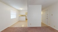 Located at 8604 Dyer St in El Paso, TX, this single-floor unit offers a straightforward and functional layout designed for comfortable everyday living. The open living area is carpeted in a warm neutral tone and benefits from natural light through a window with blinds, creating a bright and welcoming atmosphere. A textured ceiling is present throughout the main areas of the unit.

The kitchen is efficiently designed and features white cabinetry with ample storage, a built-in dishwasher, a full-size refrigerator, a gas cooktop, and a single-basin sink. A peninsula breakfast bar connects the kitchen to the living area, providing both additional counter space and a casual dining option. The kitchen is finished with light tile flooring that contrasts neatly with the carpeted living spaces.

The bedrooms are generously proportioned, each finished with the same soft carpet and clean white walls, offering a calm and neutral environment. The rooms receive natural light through windows and provide plenty of space for furnishings. A full bathroom serves the unit, complete with a tub-shower combination, toilet, vanity with an integrated sink, and a large mirror framed above. The bathroom is finished with tile flooring and white wall tile accents, maintaining a clean and practical aesthetic throughout.