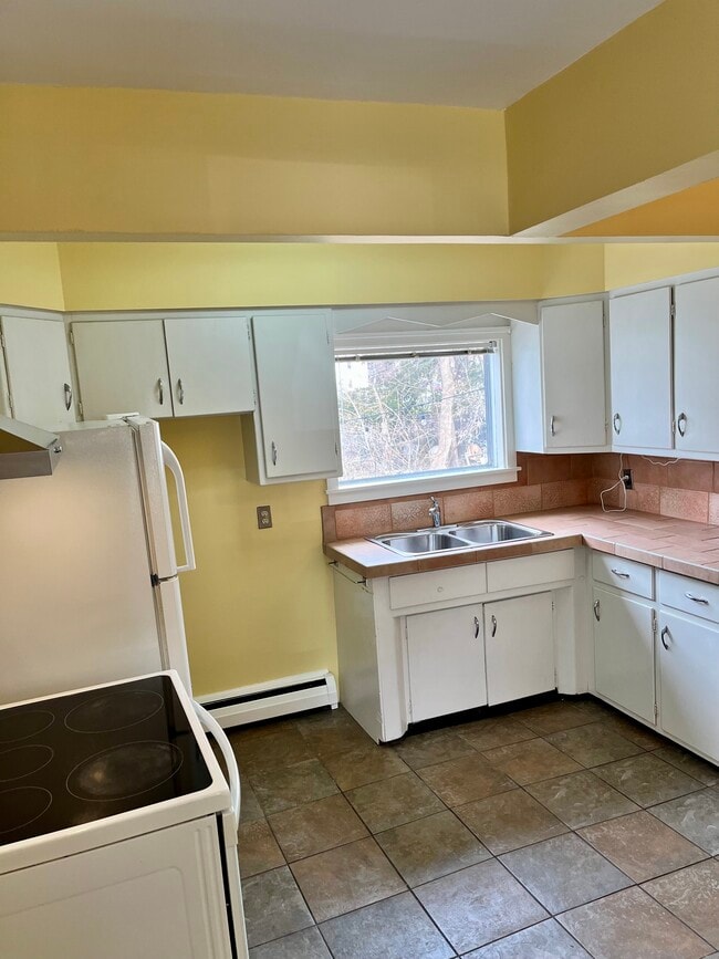 Kitchen - view from entrance of apartment. Front door to apartment opens into kitchen. - 114 Buell St