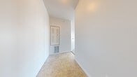 Located at 20 Brickyard Dr in Bloomington, IL, this single-story, 3-bedroom, 2-bathroom home offers a practical and well-organized layout. The combined kitchen and living room serves as the central hub of the home, with the living area featuring plush carpeting, a ceiling fan, and multiple large windows that fill the space with natural light and provide outdoor views. A glass exterior door adds additional brightness and convenient outdoor access. The kitchen is equipped with white appliances, including an electric range, dishwasher, and overhead ventilation, complemented by light wood cabinetry and tile flooring. A dedicated laundry area with built-in cabinetry and an electrical panel provides added functionality. The three bedrooms are carpeted and well-lit, with the primary bedroom offering a comfortable footprint and a walk-in closet with built-in shelving. Additional closet space is present throughout. The two bathrooms feature tile flooring, vanities with mirrors, and a bathtub. A central hallway connects the rooms efficiently. Clean white walls and neutral finishes throughout give the home a bright, move-in-ready feel.