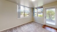 Located at 2032 Southwest Merlo Court in Beaverton, Oregon, this single-story residence offers a practical and well-organized layout across three bedrooms and three full bathrooms. The interior features a mix of wood-look flooring and plush carpeting throughout, giving each room a distinct character while maintaining a cohesive, neutral palette of soft whites and warm beige tones.

The kitchen is equipped with light wood cabinetry, gray laminate countertops, a double stainless steel sink, and a dishwasher, providing ample storage and counter space. A separate dining room and living room offer dedicated spaces for everyday living. The long connecting hallway efficiently links the main living areas to the private bedrooms.

Each bedroom is carpeted and benefits from natural light via windows with horizontal blinds. The bedrooms include closet space, with one featuring sliding double doors and another with access to a walk-in closet finished with wood-look flooring and wire shelving. The five closets throughout the home provide generous storage options.

The three bathrooms include wood-look flooring, vanities with laminate countertops, and shower/tub combinations. A dedicated laundry area adds everyday convenience. The overall ambiance is clean, neutral, and move-in ready, suited for comfortable single-floor living.