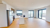 Located at 611 Davenport Rd in Waterloo, Ontario, this modern 2-bedroom, 2-bathroom unit offers a thoughtfully designed open-concept layout with high-end finishes throughout. Light hardwood flooring flows seamlessly across the living areas, complementing the bright, neutral palette and recessed lighting overhead.

The kitchen is a standout feature, equipped with stainless steel appliances, two-tone cabinetry combining white and warm wood finishes, a quartz countertop island with an integrated sink, and a window framing wide-open views of the surrounding landscape. The kitchen opens directly into a generous living area filled with natural light from large windows and sliding glass doors leading to an expansive balcony. The balcony offers sweeping panoramic views of Waterloo's treetops and skyline — a defining feature of this elevated unit.

Both bedrooms are well-proportioned, with large windows that capture natural light and outdoor views, along with clean white walls and hardwood flooring. A dedicated closet provides practical storage. The two bathrooms are finished with neutral tile flooring and clean white fixtures. The primary bathroom features a frameless sliding glass shower enclosure, while the second bathroom includes a full soaker tub and a modern vanity with ample storage.