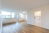 This 660 square foot apartment in Toronto offers a blend of modern convenience and efficient design. The space comprises two bedrooms, including a primary bedroom of 150 square feet, and one bathroom. The open-concept living area combines the kitchen and living room, maximizing the use of space.

The apartment features sleek, contemporary finishes throughout. Warm wooden floors extend across most rooms, contrasting beautifully with crisp white walls and baseboards. Large windows in the living area and bedrooms flood the space with natural light and offer picturesque views of the surrounding cityscape.

The kitchen is equipped with stainless steel appliances, including a refrigerator and electric stove. White cabinetry provides ample storage, while the layout allows for easy movement and functionality. The bathroom showcases elegant neutral-toned tiling and a modern white bathtub.

Storage solutions include a closet with built-in shelving, ideal for organizing personal belongings. The apartment's single floor layout ensures easy accessibility throughout. Baseboard heating units are strategically placed for comfort during colder months.

Located at 280 St George St, this apartment puts residents in the heart of Toronto, surrounded by urban amenities. The efficient use of space, coupled with its prime location, makes this apartment an attractive option for those seeking a comfortable city dwelling.