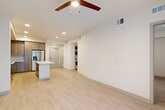 Located at 495 Centerpointe Circle in Altamonte Springs, FL, this modern single-floor residence offers a thoughtfully designed open-concept layout that seamlessly connects the living, dining, and kitchen areas. Light wood-tone flooring flows throughout, complementing the clean, neutral color palette that gives the space a bright and airy feel.

The kitchen is a standout feature, showcasing flat-front cabinetry in a warm wood finish, white quartz countertops, a subway tile backsplash, and a full suite of stainless steel appliances including a French door refrigerator with ice maker, electric range, over-the-range microwave, and dishwasher. A central island provides additional counter space and casual dining potential.

The living area benefits from floor-to-ceiling sliding glass doors that invite abundant natural light and outdoor views, and is topped with a ceiling fan for year-round comfort. The bedroom is a comfortable, well-proportioned retreat with a large window fitted with roller shades and a dedicated closet.

The bathroom features marble-look tile flooring, a soaking tub with shower, a wall niche, and a wood-tone vanity with white countertop. A dedicated laundry area with a stacked washer and dryer adds everyday convenience, while a separate utility room houses the electrical panel.