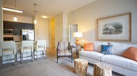 Located at 400 S Military Hwy in Virginia Beach, VA, this single-floor residence offers a thoughtfully designed layout with a warm, neutral palette throughout. The living room is a welcoming space featuring plush carpeting, abundant natural light from large sliding glass doors with vertical blinds, and seamless access to an outdoor patio area with views of the surrounding greenery.

The kitchen is well-equipped with dark espresso cabinetry, crisp white countertops, tile flooring, and stainless steel appliances including an electric range and over-the-range microwave, providing a functional and stylish cooking environment.

The bedrooms are generously sized with soft carpeting, large windows that invite natural light, and ample wall space. Each room carries a calm, restful ambiance with neutral tones and elevated ceiling heights visible in select rooms.

Two bathrooms serve the residence, each featuring tile flooring, dark vanity cabinetry with white countertops, and large mirrors. One bathroom includes a soaking tub and shower combination, while the second offers a refined, efficient layout with a full vanity and toilet.

Overall, this residence presents a clean, contemporary aesthetic with consistent finishes throughout, offering comfortable and functional living spaces in a convenient Virginia Beach location.