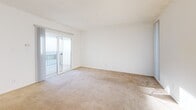 Located at 760 Earlham St in Pasadena, CA, this one-bedroom, one-bathroom residence offers a thoughtfully organized single-floor layout. The combined living and dining area is bright and open, finished with neutral carpet and bathed in natural light from sliding glass doors that lead to a private balcony with open views. The kitchen is well-equipped, featuring white cabinetry, granite-style countertops, stainless steel appliances including a refrigerator and dishwasher, and warm hardwood-style flooring that extends throughout the functional areas of the home. The bedroom is a comfortable retreat with hardwood-style flooring, a ceiling fan, a bright window, and access to generous closet space with built-in shelving. The bathroom is cleanly designed with a white vanity, ample under-sink storage, a soaking tub with natural stone tile surround, and a frosted privacy window that allows soft natural light to filter in. With four closets distributed throughout the unit, storage is a notable strength of this home. The clean, white interiors and consistent flooring choices lend the space a cohesive and airy feel throughout.