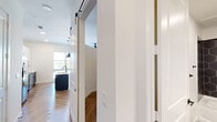This efficient and well-appointed one-bedroom, one-bathroom unit showcases a clean, modern aesthetic with carefully selected finishes throughout. The open-concept layout is anchored by a striking kitchen featuring a two-tone cabinetry design — dark lower cabinets paired with crisp white uppers — complemented by a white quartz waterfall island with an undermount sink and dual matte black pendant lights overhead. Stainless steel appliances, including a side-by-side refrigerator with ice and water dispenser, electric range, and microwave, complete the functional kitchen setup. A classic white subway tile backsplash adds a timeless touch. Herringbone-patterned wood-look flooring flows throughout the unit, adding visual interest and warmth to every room. Natural light enters through large windows fitted with horizontal blinds. A sliding barn door provides a stylish transition between spaces. The bedroom offers neutral walls and the same herringbone flooring, providing a calm and versatile canvas. The bathroom features a tub-shower combo adorned with bold, large-format hexagonal dark grey wall tile, creating a striking and contemporary focal point. Overall, the space delivers a modern and cohesive design with functional, quality finishes.