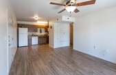 Located at 5757 Will Ruth Ave in El Paso, Texas, this single-floor unit offers a straightforward and functional layout finished with consistent wood-look flooring throughout. The living area is open and inviting, featuring a ceiling fan, a paneled entry door, and a sliding glass door that lets in natural light and provides access to the outdoors. Wall sconces add a warm ambiance to the connecting hallway area. The kitchen is efficiently designed with warm-toned wood cabinetry, granite-style countertops, a double-basin sink, and white appliances including a gas range, dishwasher, refrigerator, and over-the-range microwave — providing a well-equipped cooking space. The bedrooms are bright and simply finished, each with wood-look flooring, ceiling fans, and windows fitted with blinds that allow natural light while maintaining privacy. The bathroom includes a vanity with granite-style countertops, a tub-shower combination, and coordinating wood-look flooring. Throughout the unit, clean white walls, six-panel interior doors, and consistent flooring create a cohesive and neutral living environment suited for comfortable everyday living.