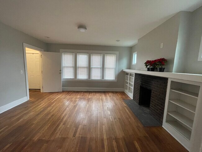 Front door entrance has big closet! Living room. Original hardwood floor and original book shelf - 2241 W Euclid St