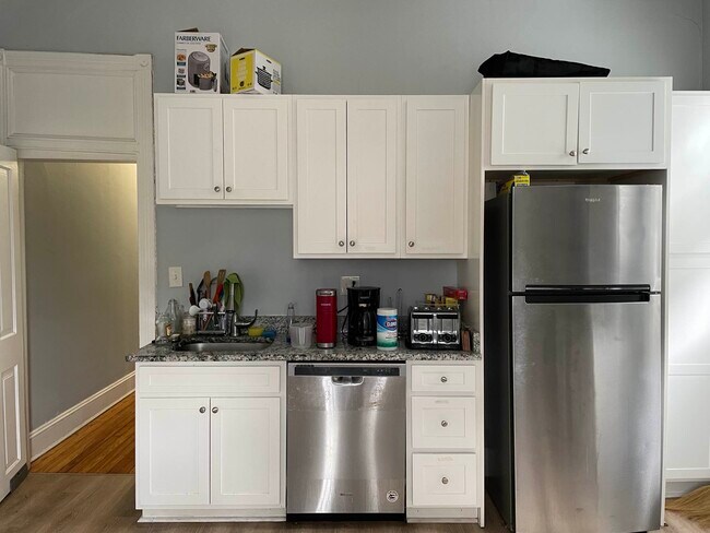 Renovated kitchen with new fridge and dishwasher and granite countertops - 1204 John St