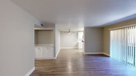 Located at 6131 North 16th Street in Phoenix, AZ, this single-floor, 2-bedroom, 2-bathroom residence offers a thoughtfully designed layout with a blend of comfort and modern updates. The open-concept living and dining area is anchored by warm wood-look flooring, a ceiling fan, and a built-in cabinet niche that adds a charming architectural detail. A sliding glass door floods one end of the living space with natural light and provides direct access to an outdoor area. The galley-style kitchen is a standout feature, boasting white shaker cabinetry, white quartz countertops, subway tile backsplash, stainless steel appliances, and a skylight that brightens the space. Both bedrooms are carpeted for comfort and feature windows that invite natural light. The generously sized primary bedroom includes an expansive set of sliding-door closets, offering abundant storage. Each bathroom is clean and functional, featuring a full tub-shower combination, modern chrome fixtures, and wood-look flooring. Neutral, warm-toned walls throughout create a cohesive and inviting atmosphere, making this residence a practical and comfortable home in Phoenix.