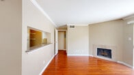 Located at 4034 Highway 6 S in Houston, TX, this single-floor, one-bedroom, one-bathroom unit offers a well-organized layout across a compact yet functional footprint. The living room serves as the heart of the space, showcasing warm hardwood flooring, crown molding, and a tiled fireplace that adds a classic touch. Sliding glass doors lead directly to a private balcony, filling the room with natural light. The open flow connects the living area to the dining space, both finished in the same rich hardwood floors and neutral warm-toned walls throughout.

The kitchen features light tile flooring, white cabinetry, granite-style countertops, a full suite of white appliances, a pass-through window opening to the main living area, and an adjacent pantry for additional storage.

The spacious bedroom accommodates a generous footprint, complete with hardwood floors, a ceiling fan, a window with blinds, and access to a large walk-in closet outfitted with multiple shelving rods and ample storage capacity.

The bathroom offers light tile flooring, a full soaking tub, and diagonal-set tile surround. The dining area transitions to tile flooring, completing a cohesive and practical design throughout the unit.