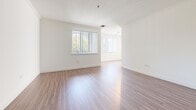 Located at 5710 Crescent Park E in the vibrant Playa Vista neighborhood of Los Angeles, this one-bedroom, one-bathroom residence offers a thoughtfully designed layout with modern finishes throughout. Wide-plank wood-look flooring flows seamlessly across the open-concept living and kitchen areas, creating a cohesive and inviting atmosphere.

The kitchen is a standout feature, showcasing rich walnut-toned upper cabinetry, dark lower cabinets, and a slate-blue subway tile backsplash. A central peninsula with a stainless steel countertop provides additional prep space and casual seating potential. Stainless steel appliances — including a gas range, built-in microwave, dishwasher, and refrigerator — complete the well-equipped culinary space. Pendant and track lighting overhead add both function and style.

The living area benefits from natural light streaming through a large window, offering views of lush greenery outside. The bedroom is a comfortable retreat, featuring its own window with garden views and direct access to the hallway and closet with built-in shelving.

The bathroom is finished with grey hexagonal floor tile, a wood-framed vanity mirror, a combination tub and shower with white tile surround, and open shelving for storage. Clean white walls and crisp trim throughout give the entire residence a fresh, modern feel.
