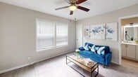 Located at 4305 Forestridge Ln in Kannapolis, NC, this well-designed one-bedroom, one-bathroom residence offers a thoughtful single-floor layout that maximizes every square foot. The living room serves as the heart of the home, featuring neutral gray walls, plush carpeting, a ceiling fan with light fixture, and a large window dressed with white horizontal blinds that invite natural light into the space. The open sightline from the living area connects seamlessly to the kitchen, creating a cohesive and functional flow. The kitchen stands out with crisp white shaker-style cabinetry, light stone-finish countertops, a full suite of stainless steel appliances including a refrigerator, range, microwave, and dishwasher, as well as a window above the sink that brings in additional natural light and wood-look luxury vinyl flooring. The bedroom is a comfortable retreat, also finished with soft carpeting and a ceiling fan, offering two closets for ample storage and a window that keeps the room bright. The bathroom is clean and functional, complete with a full tub and shower combination. Throughout the residence, a consistent neutral color palette and modern finishes create a cohesive, move-in ready atmosphere suited for comfortable everyday living.